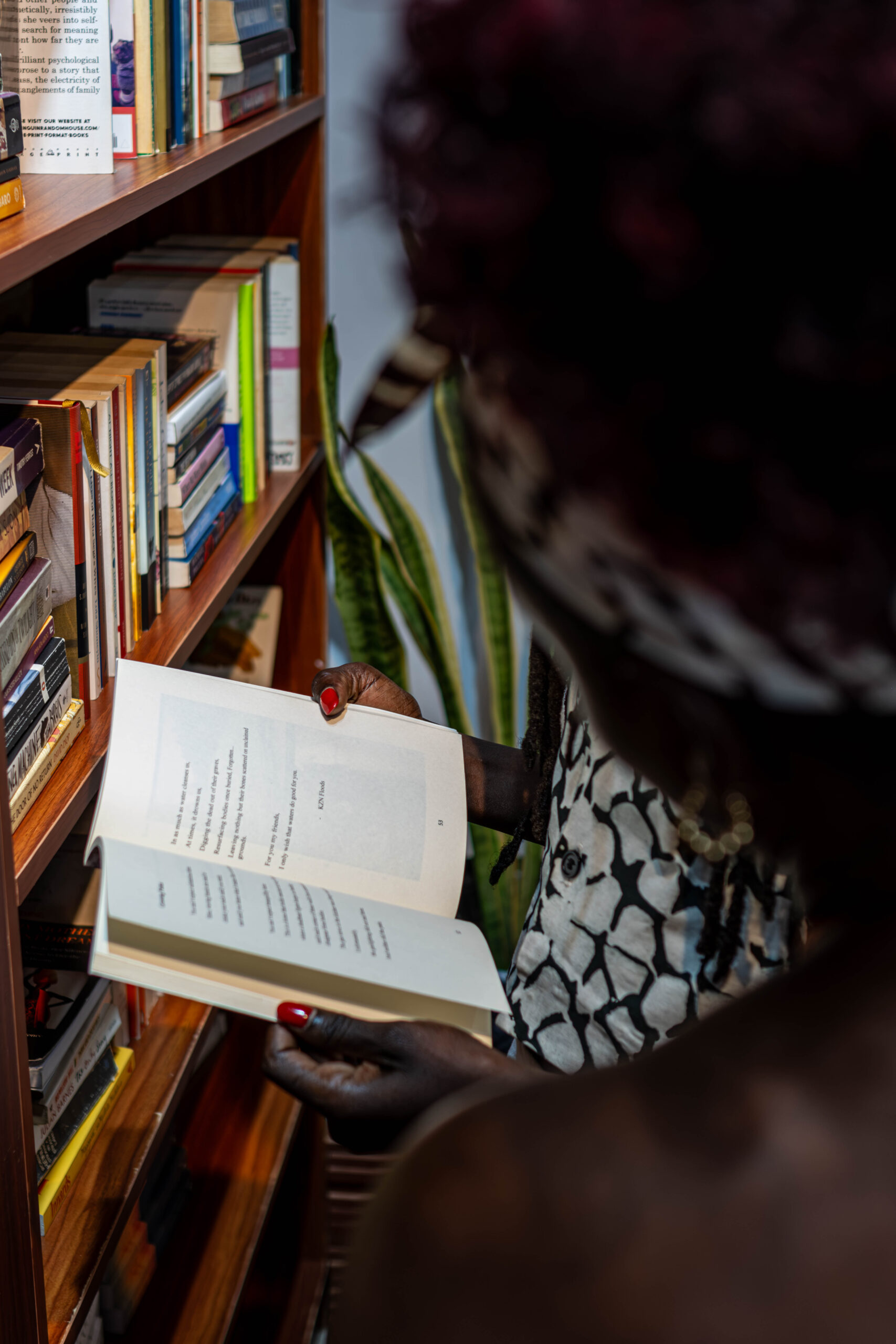 A reader spending time among the shelves at Kakule Bookstore